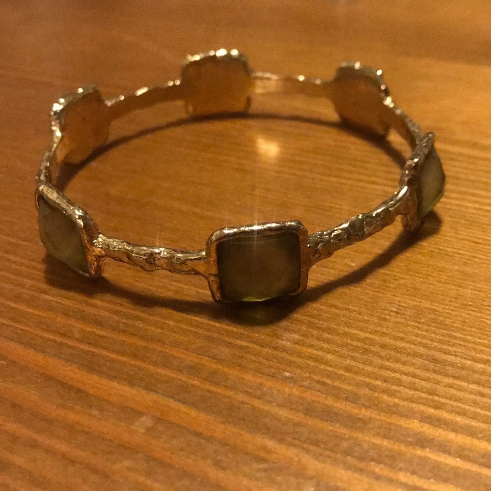 Lightly green gem and gold bangle bracelet